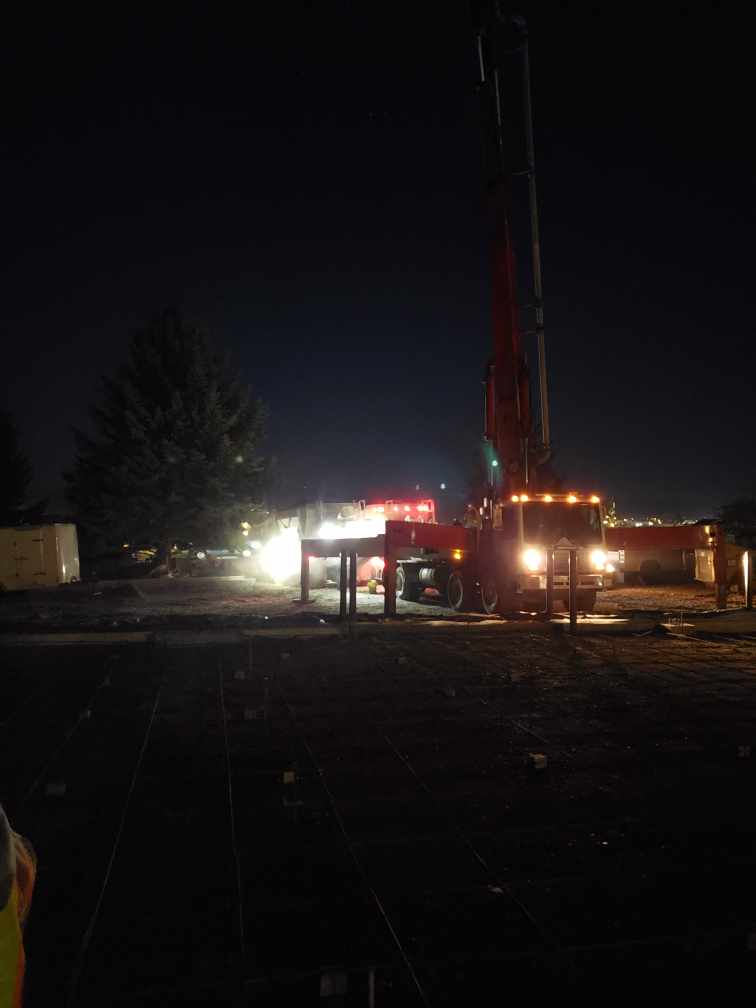 Concrete pump truck preparing for conrete pour in early morning hours.
