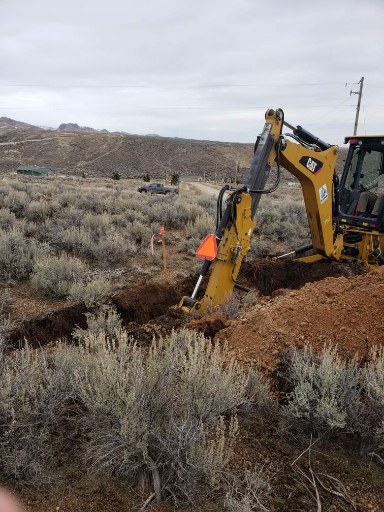 Backhoe digging percolation testing pit.